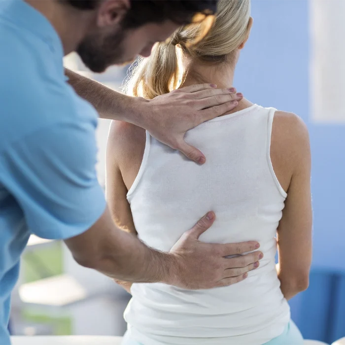 Person receiving a chiropractic adjustment on the back.